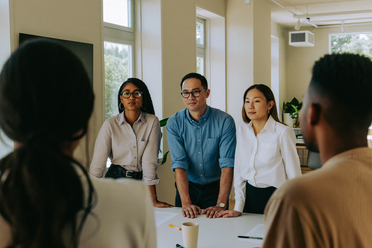 A small business team working together around a table in a bright office