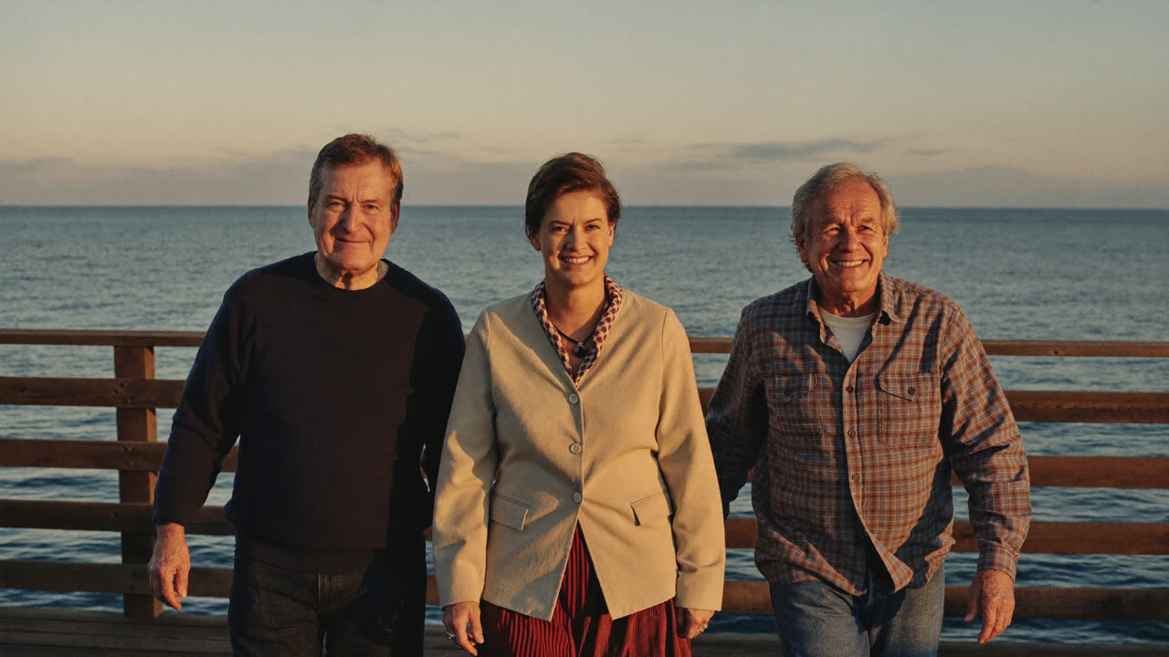 Friends of mixed ages walking along a Santa Barbara pier at sunset